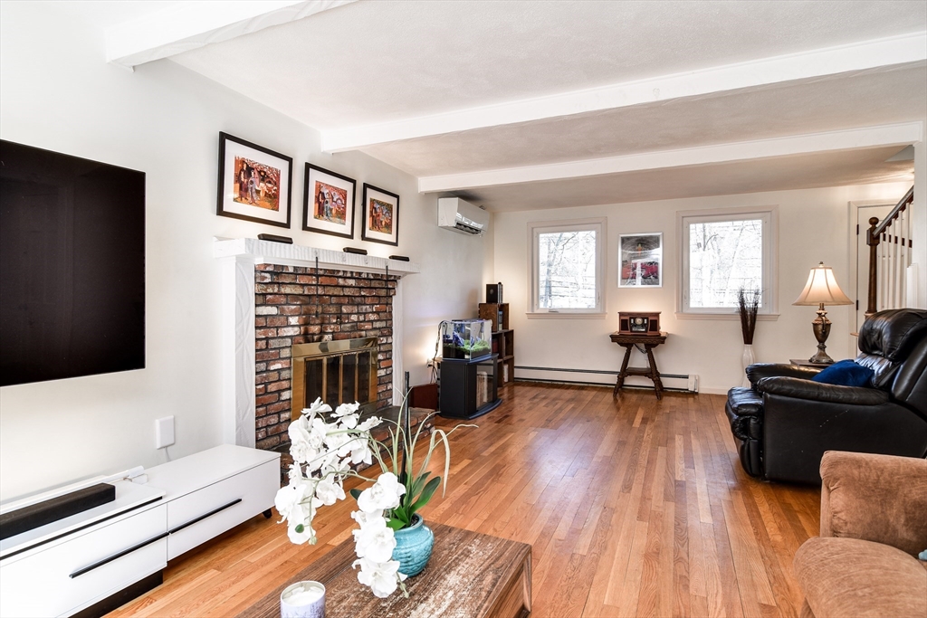 248 Liberty Square Road Boxborough, MA 01719 - Photo 12 of 31 a living room with fireplace furniture and a flat screen tv