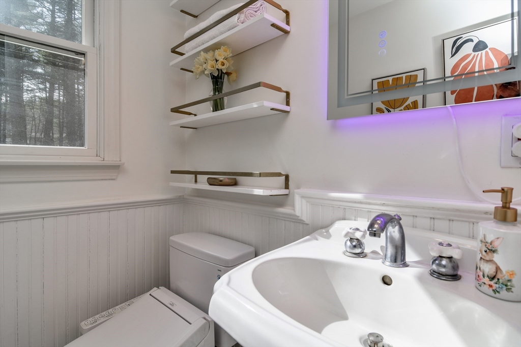 248 Liberty Square Road Boxborough, MA 01719 - Photo 17 of 31 a bathroom with a sink a toilet and a mirror