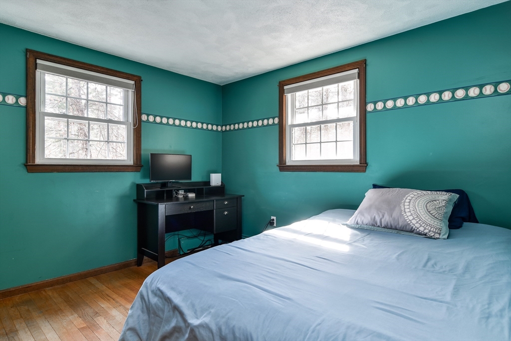 248 Liberty Square Road Boxborough, MA 01719 - Photo 20 of 31 a bedroom with a bed and a flat tv screen on dresser