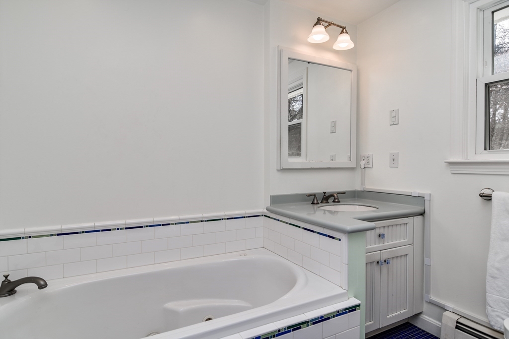 248 Liberty Square Road Boxborough, MA 01719 - Photo 23 of 31 a bathroom with a sink vanity and mirror