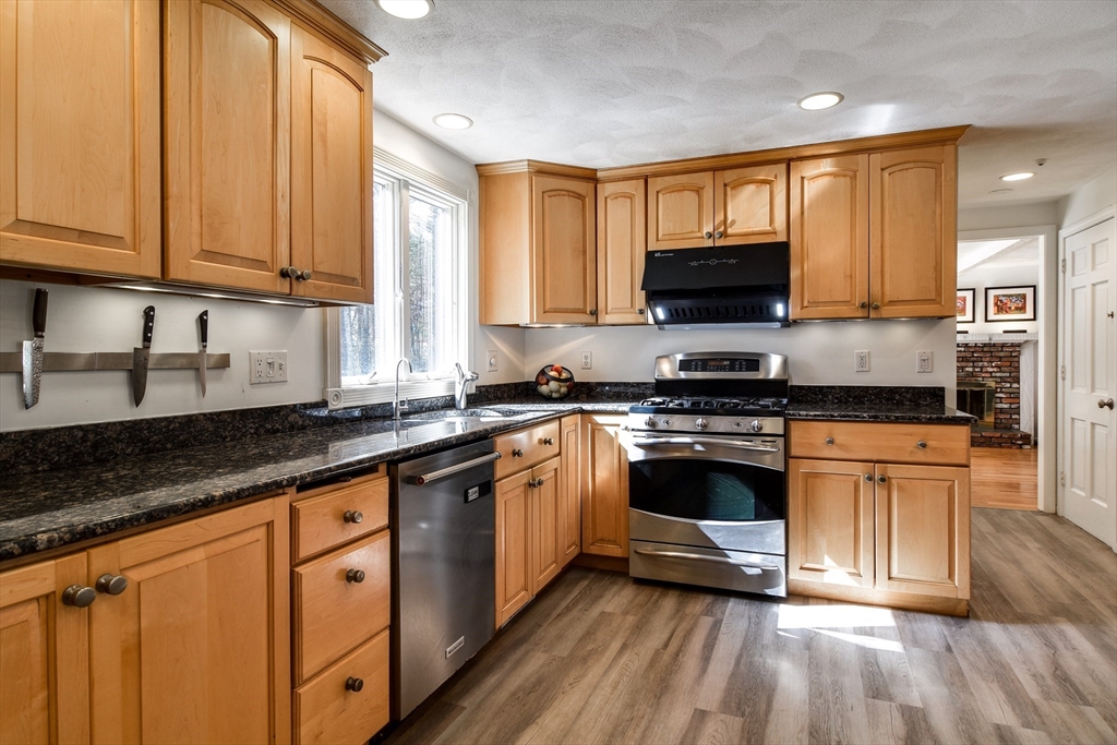 248 Liberty Square Road Boxborough, MA 01719 - Photo 3 of 31 a kitchen with stainless steel appliances granite countertop a stove a sink and a microwave