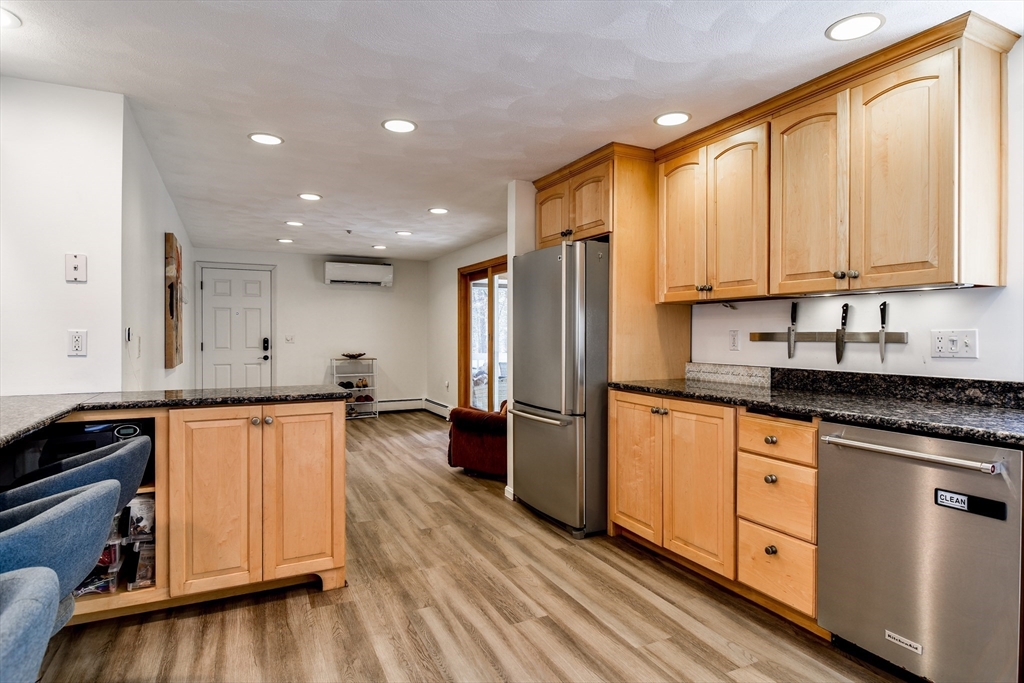 248 Liberty Square Road Boxborough, MA 01719 - Photo 4 of 31 a kitchen with stainless steel appliances granite countertop a refrigerator a stove a sink and white cabinets with wooden floor