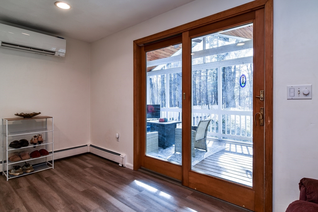 248 Liberty Square Road Boxborough, MA 01719 - Photo 7 of 31 a view of an empty room with wooden floor and a window