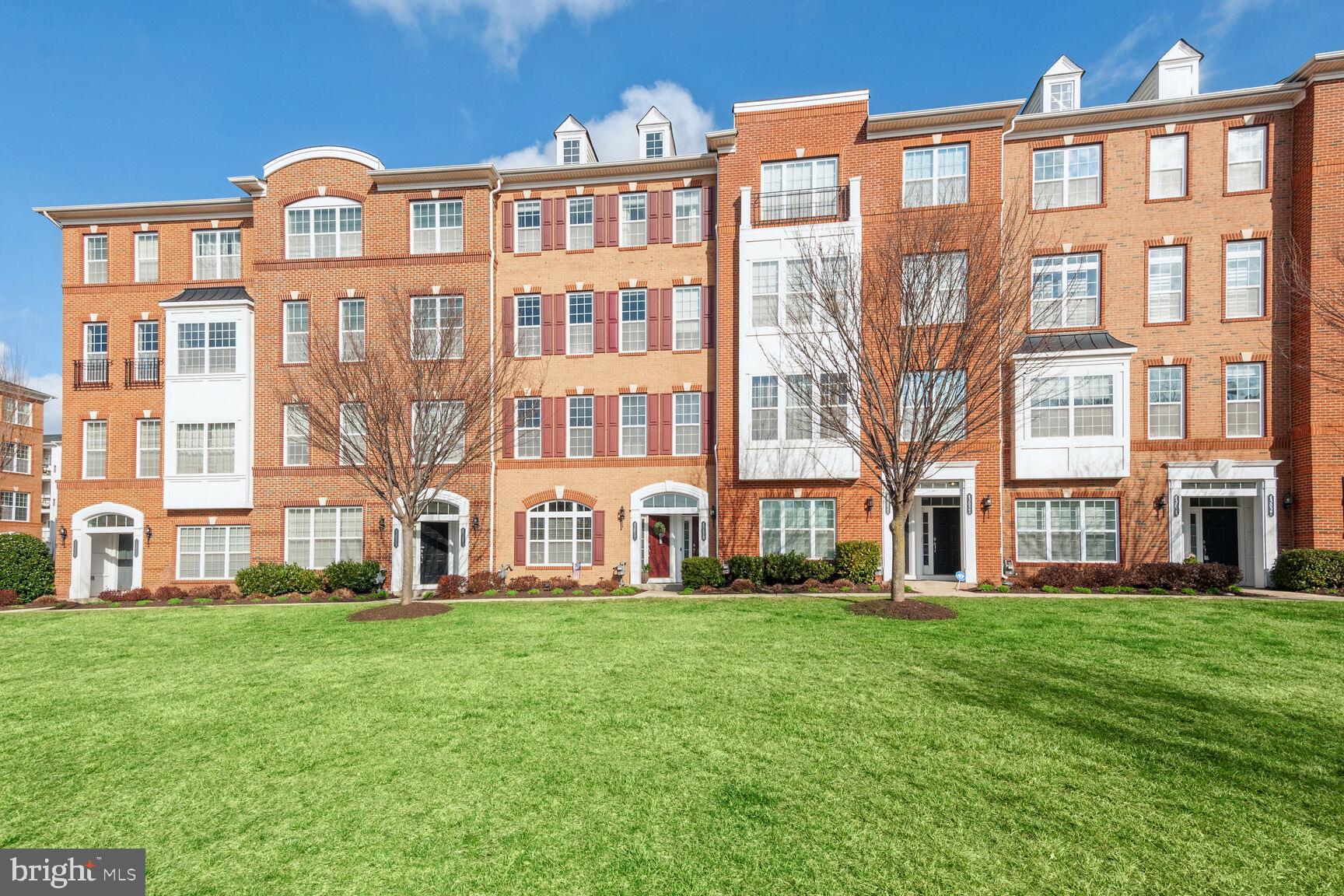 43019 Clarks Mill Terrace, Unit 806 Ashburn, VA 20148 - Photo 1 of 32 a front view of a building with a yard