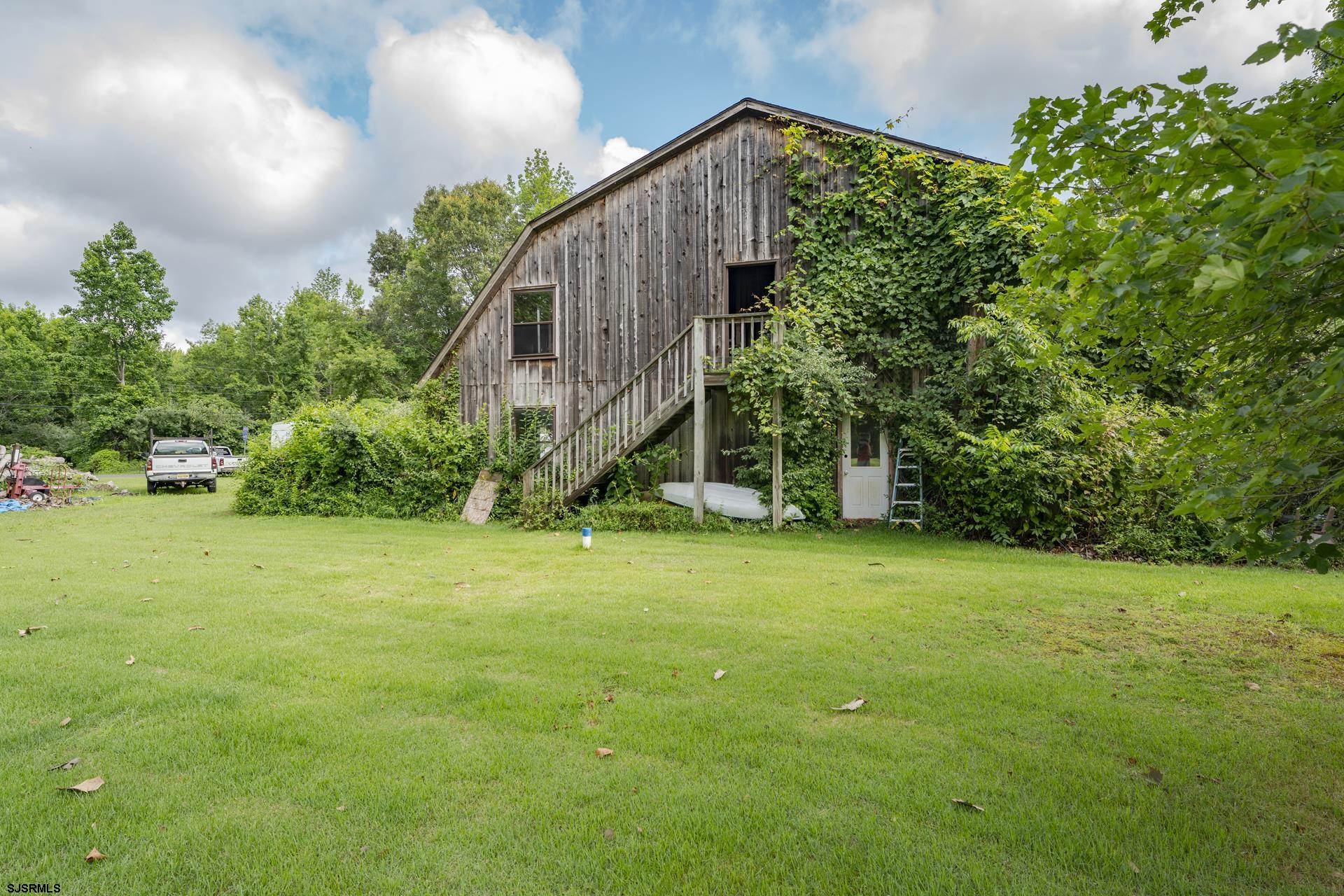 126 Buck Hill Road Corbin City, NJ 08270 - Photo 2 of 10 a view of a back yard of the house
