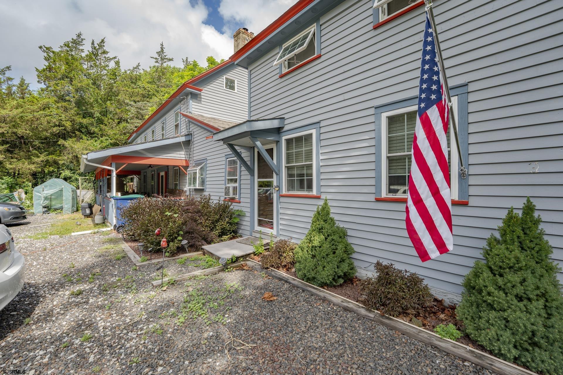 126 Buck Hill Road Corbin City, NJ 08270 - Photo 3 of 10 a front view of a house with a yard and potted plants