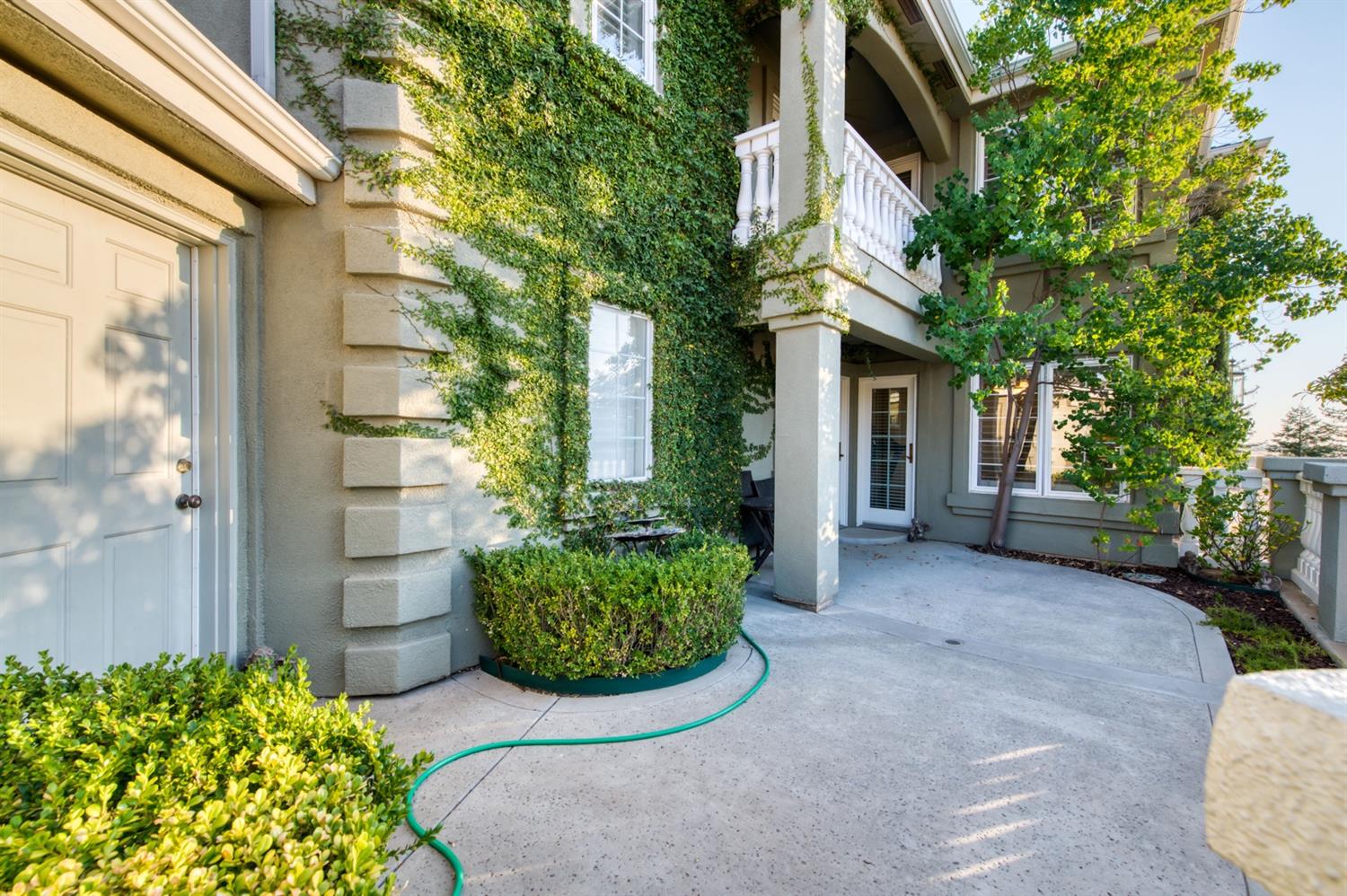 14374 Killarney Drive Madera, CA 93636 - Photo 22 of 56 a view of a house with brick walls and potted plants