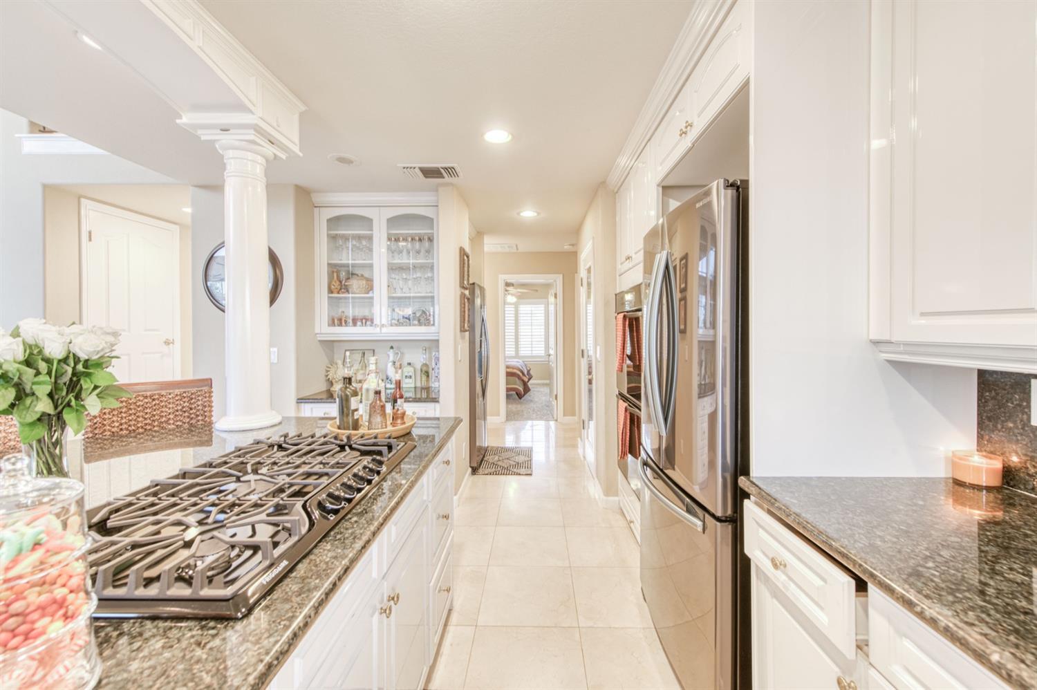 14374 Killarney Drive Madera, CA 93636 - Photo 35 of 56 a spacious bathroom with a granite countertop sink and a bathtub