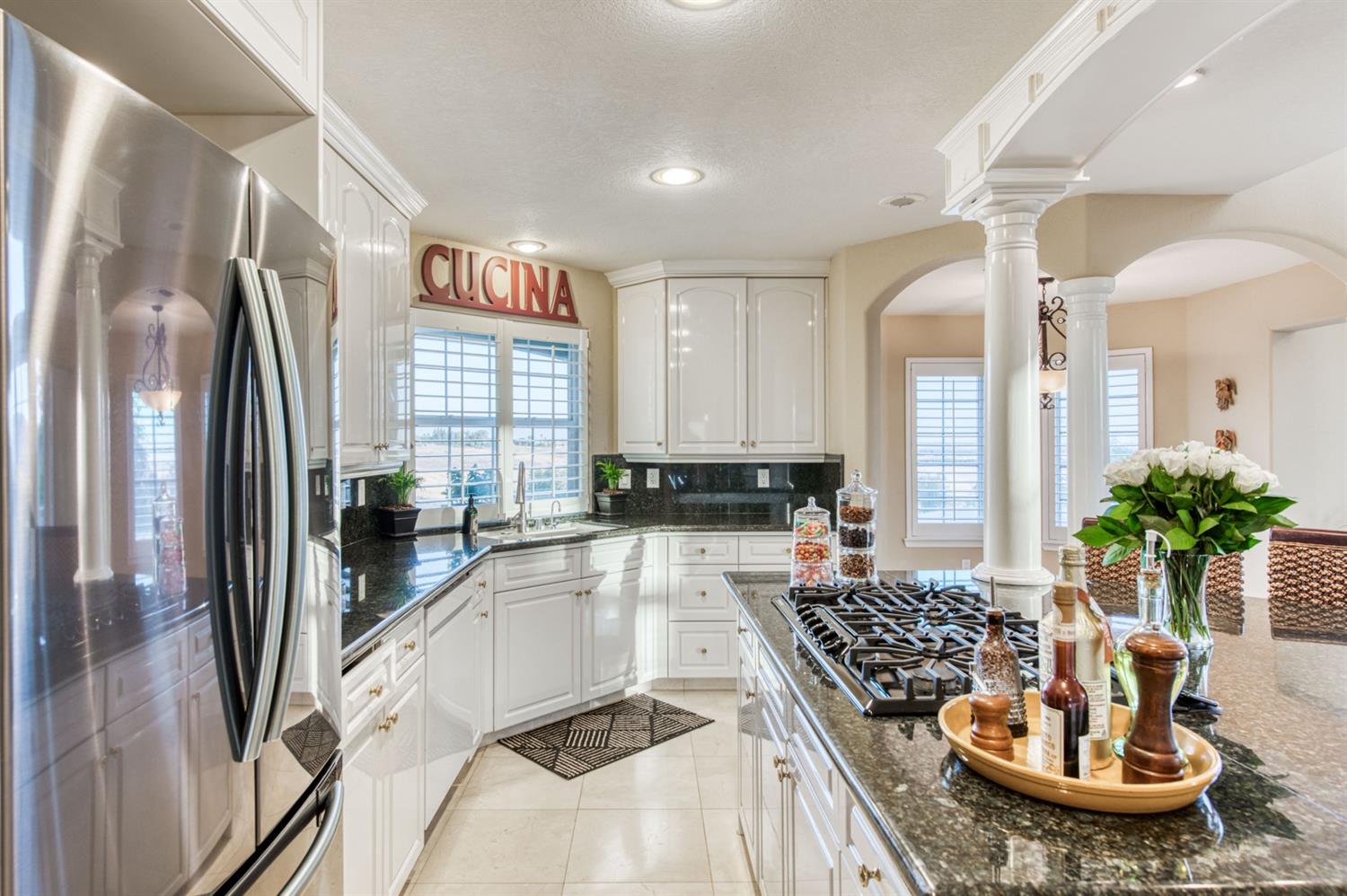14374 Killarney Drive Madera, CA 93636 - Photo 36 of 56 a kitchen with a stove a sink and a refrigerator
