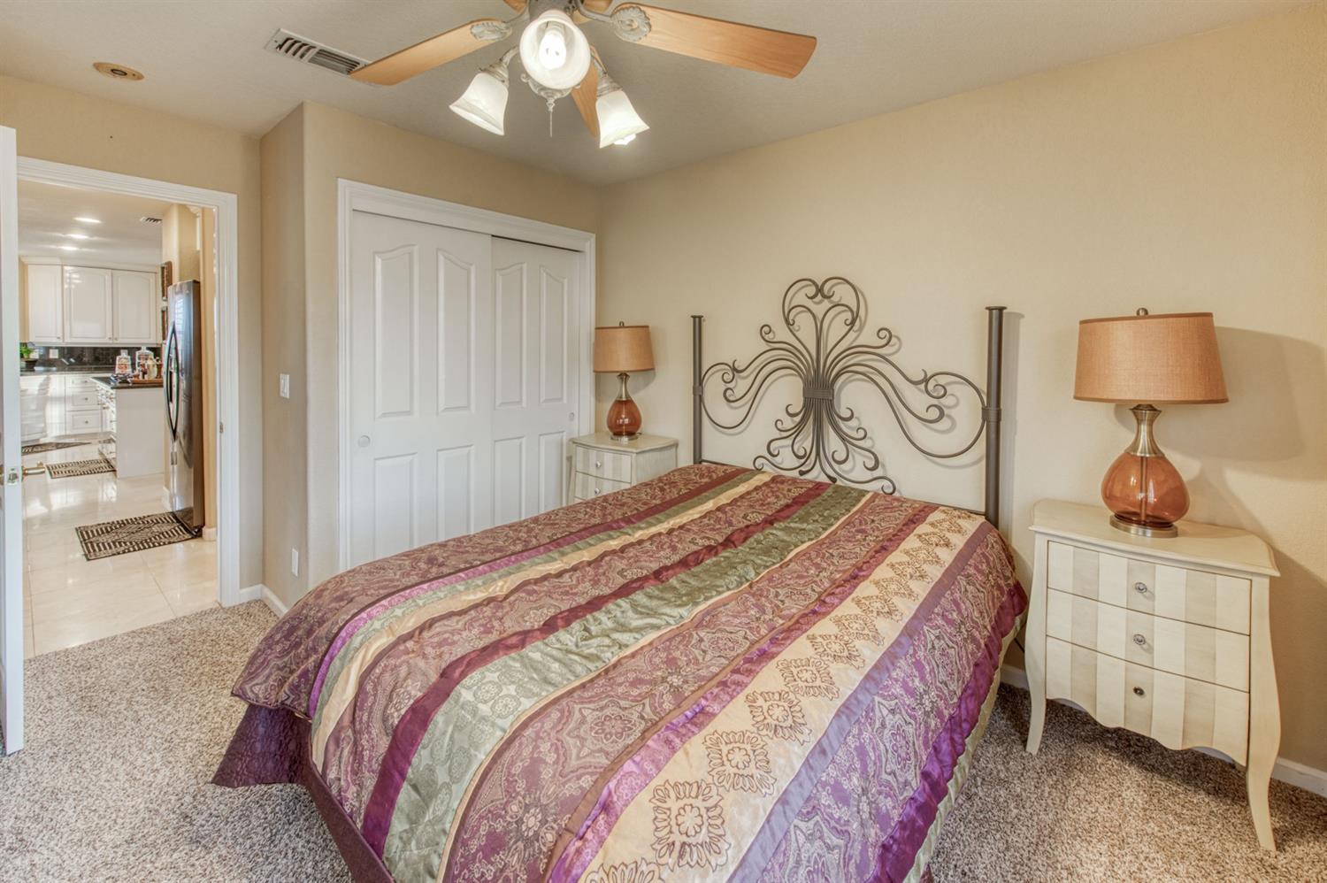 14374 Killarney Drive Madera, CA 93636 - Photo 39 of 56 a bedroom with a bed and a chandelier