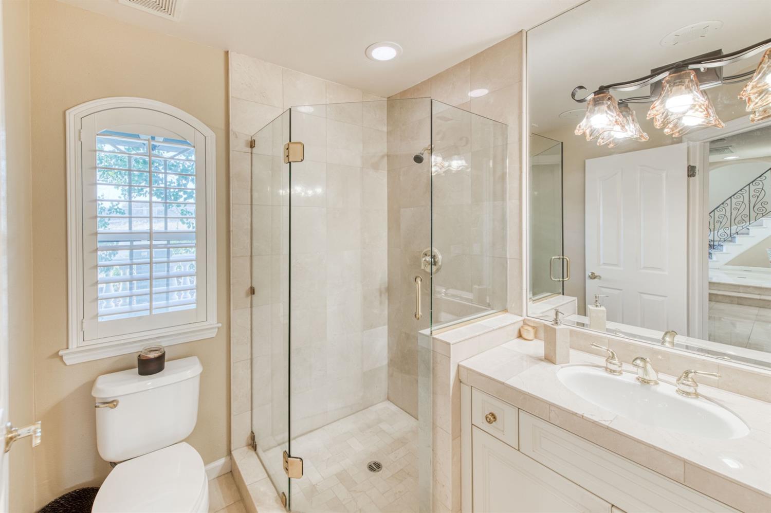 14374 Killarney Drive Madera, CA 93636 - Photo 40 of 56 a bathroom with a toilet sink and shower