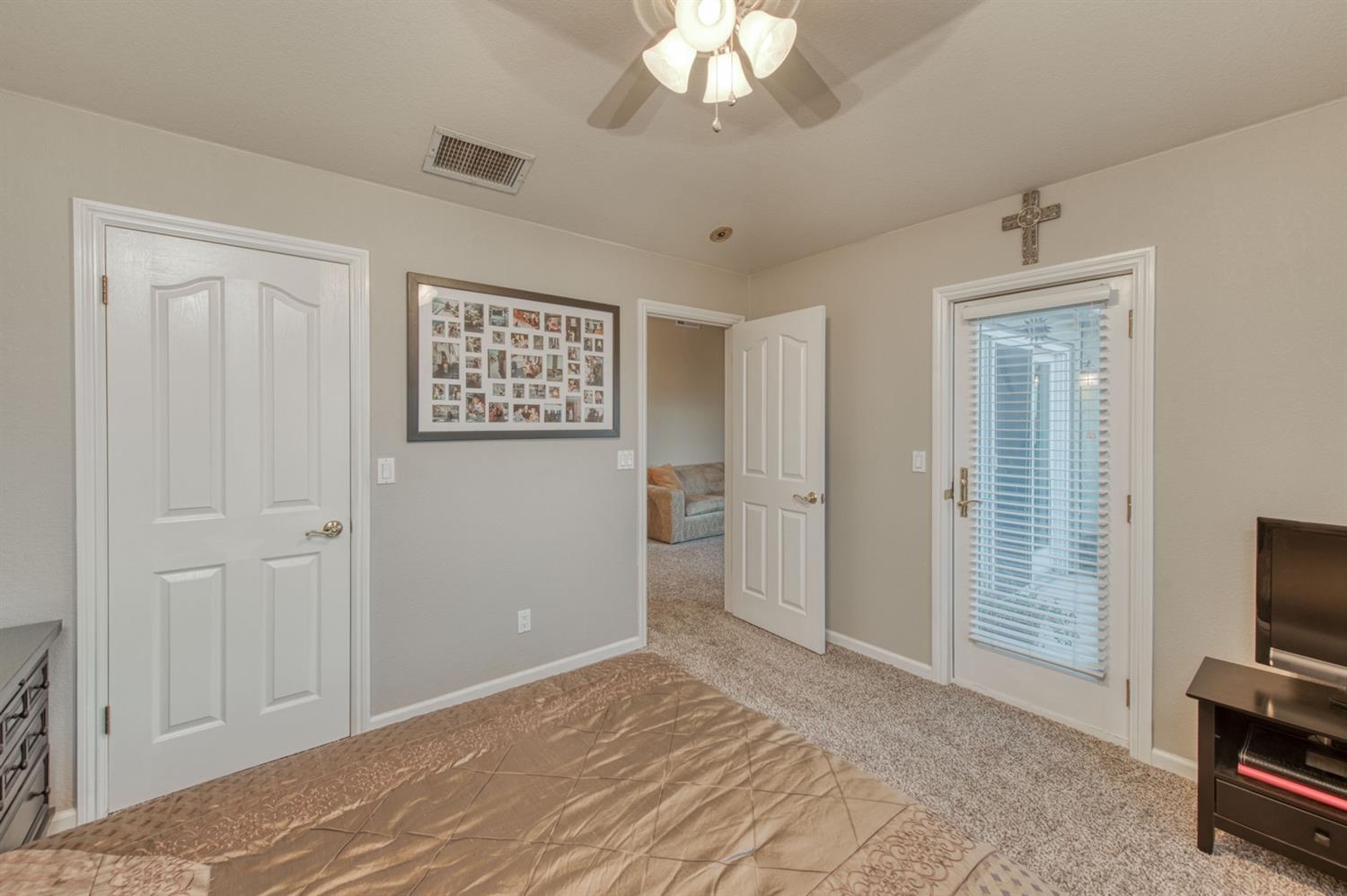 14374 Killarney Drive Madera, CA 93636 - Photo 44 of 56 a view of a bedroom with cabinet flat screen tv and closet