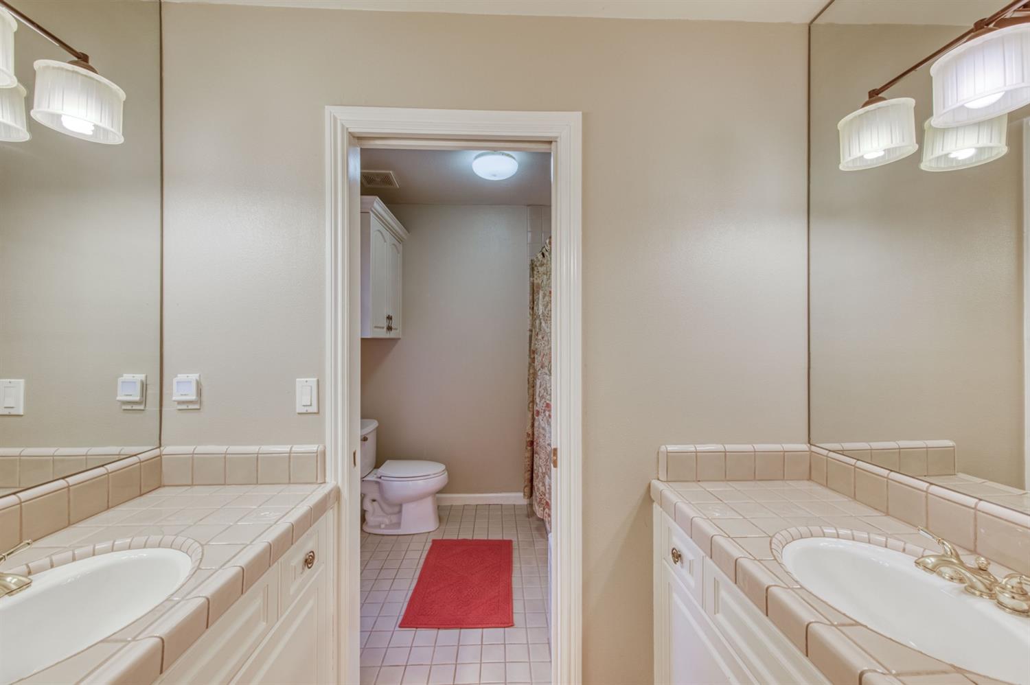 14374 Killarney Drive Madera, CA 93636 - Photo 45 of 56 a bathroom with a sink toilet vanity granite tub and shower