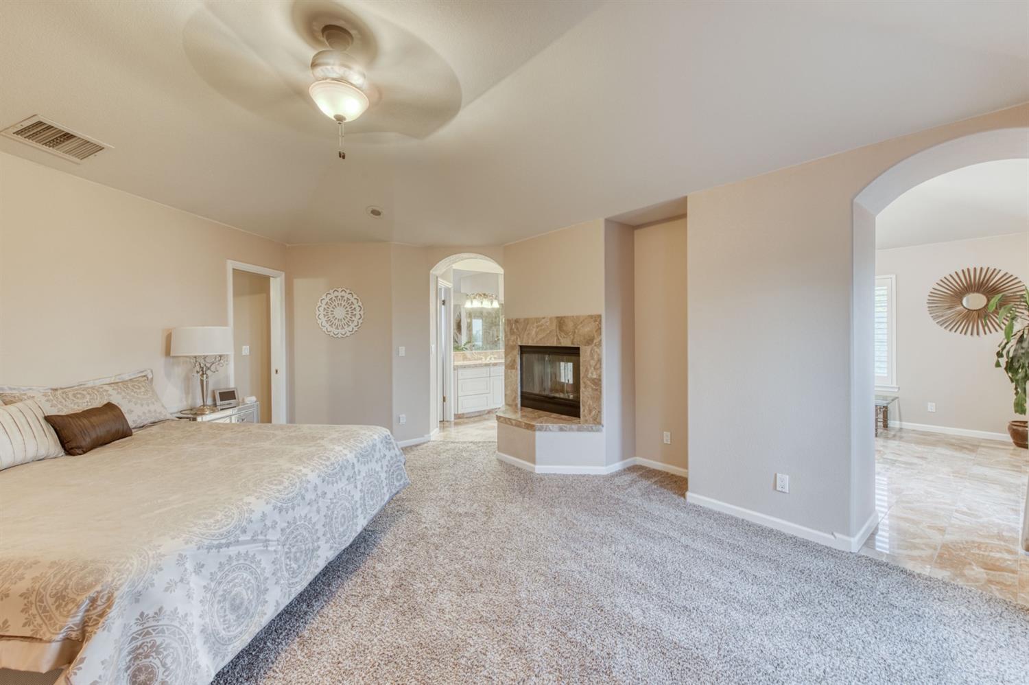 14374 Killarney Drive Madera, CA 93636 - Photo 48 of 56 a bedroom with a large bed and ceiling fan