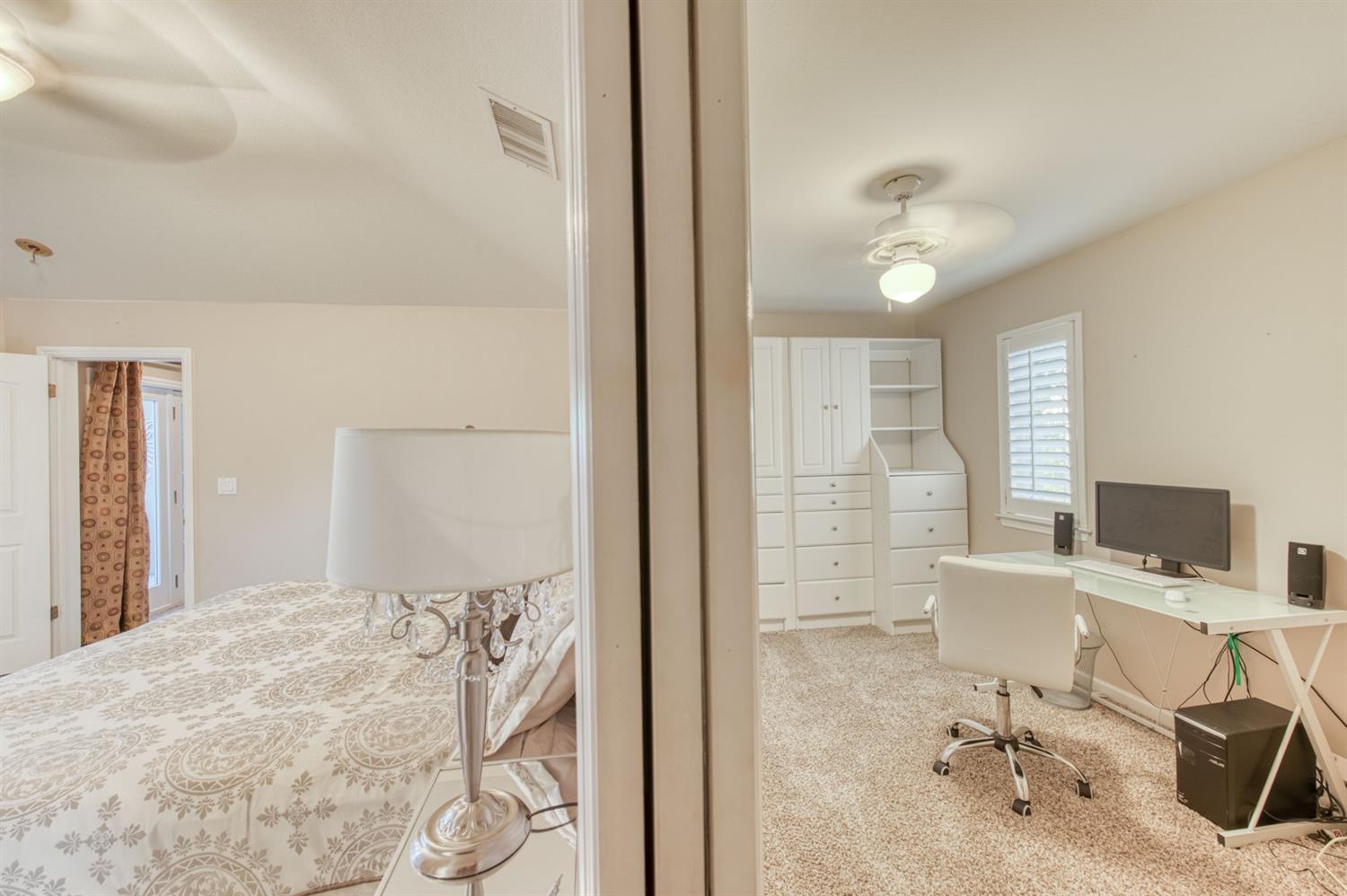 14374 Killarney Drive Madera, CA 93636 - Photo 49 of 56 a view of a bedroom with workspace and a window