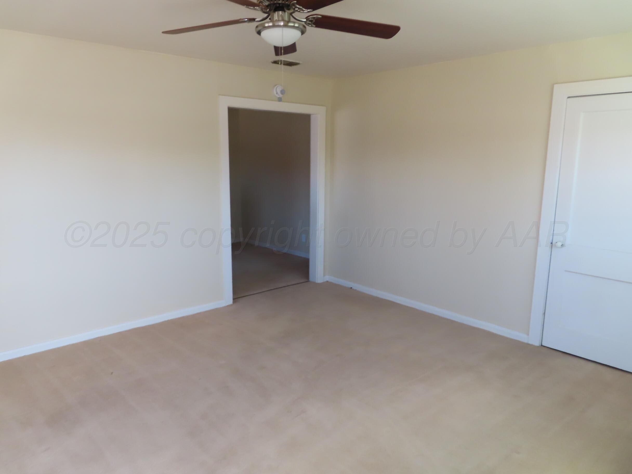 3813 South Washington Street Amarillo, TX 79110 - Photo 5 of 12 en empty room with a fan