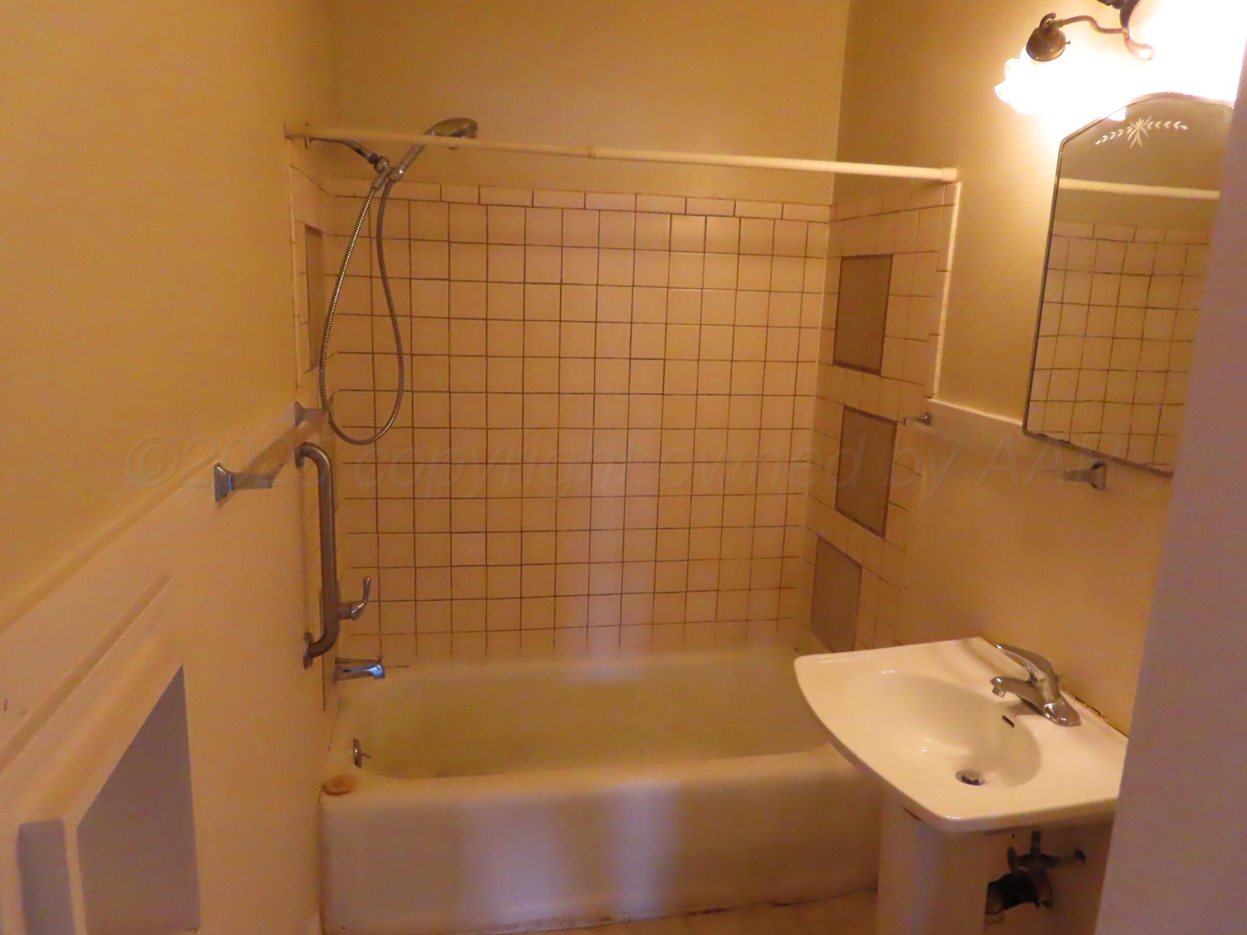 3813 South Washington Street Amarillo, TX 79110 - Photo 8 of 12 a bathroom with a sink and shower