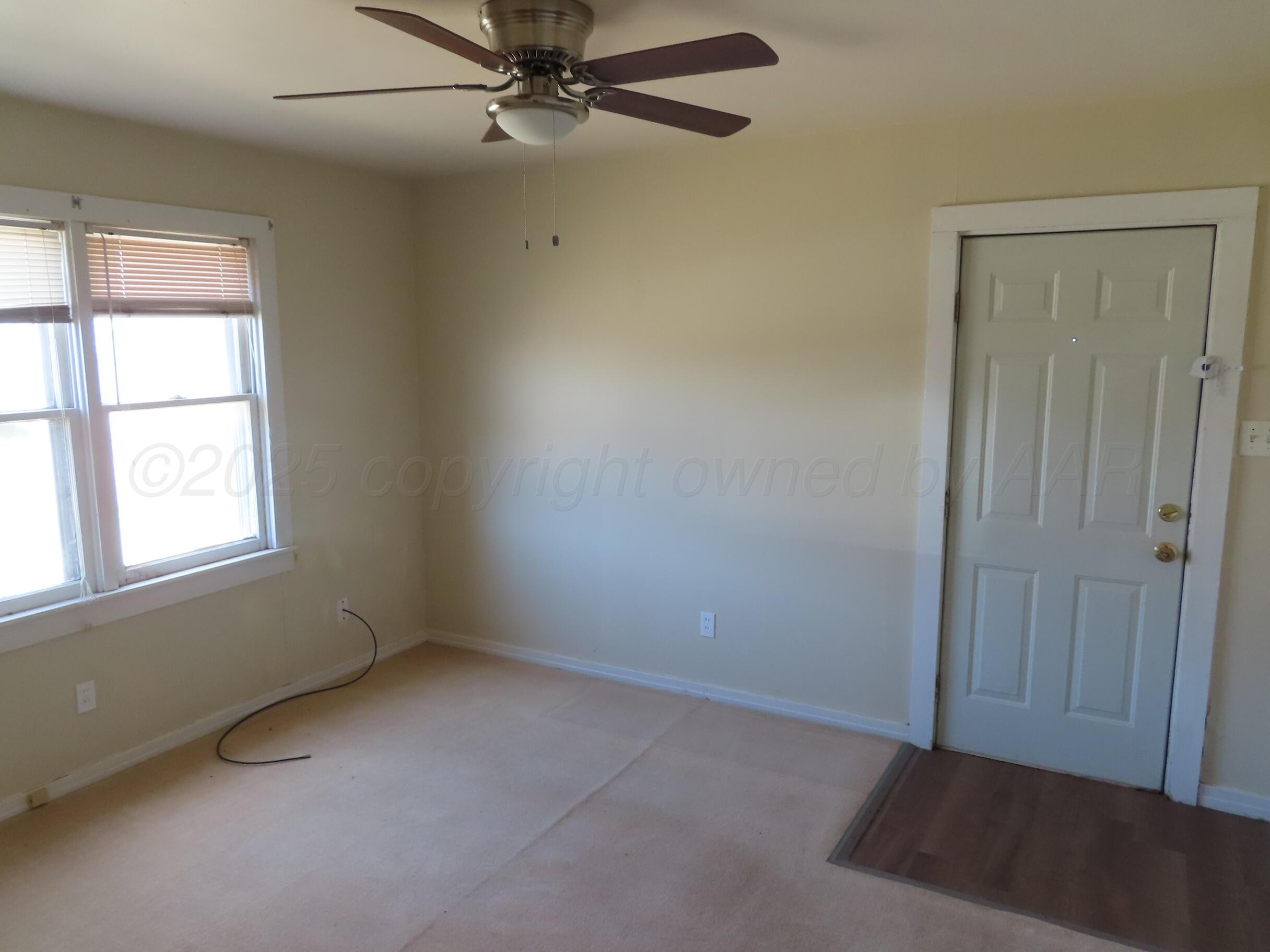 3813 South Washington Street Amarillo, TX 79110 - Photo 9 of 12 an empty room with windows and fan