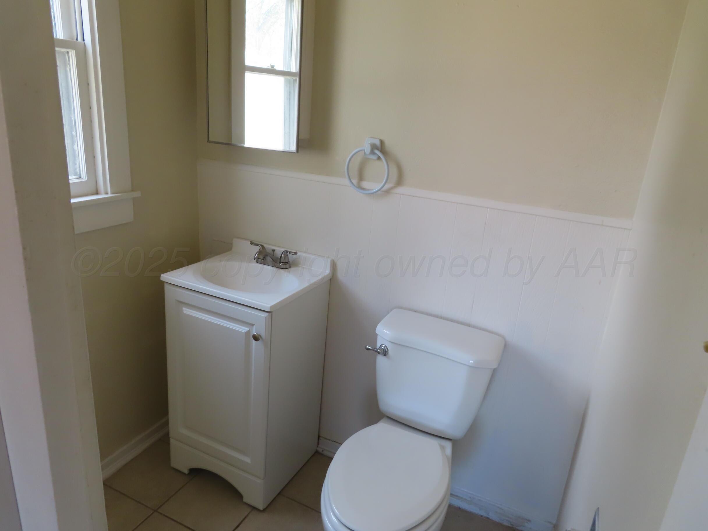 3813 South Washington Street Amarillo, TX 79110 - Photo 10 of 12 a white toilet sitting next to a white sink