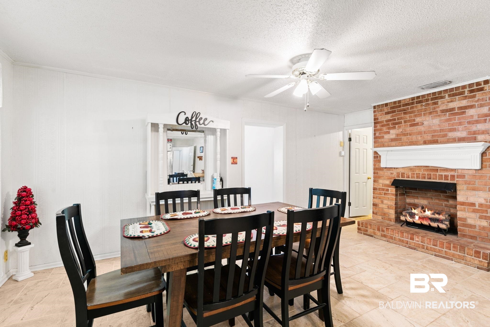 927 Cleveland Road Saraland, AL 36571 - Photo 13 of 80 Dining area featuring a brick fireplace with a white mantel, tile flooring, and a ceiling fan