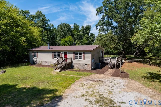 a view of a house with yard and sitting area