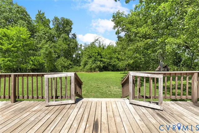 a view of balcony with wooden floor and fence