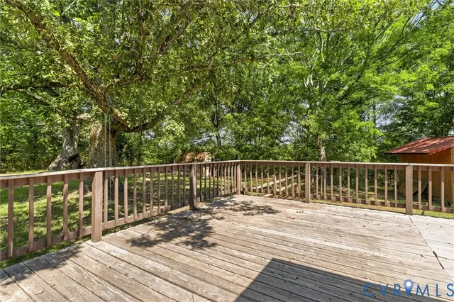 a balcony with wooden floor and fence