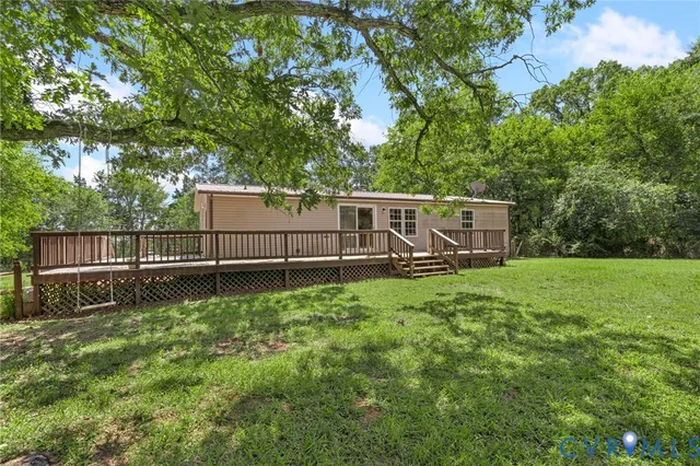 a view of backyard with deck and trees