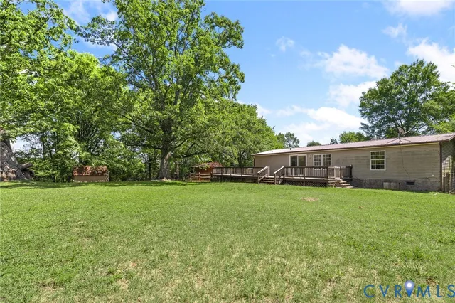 a view of a backyard with large trees