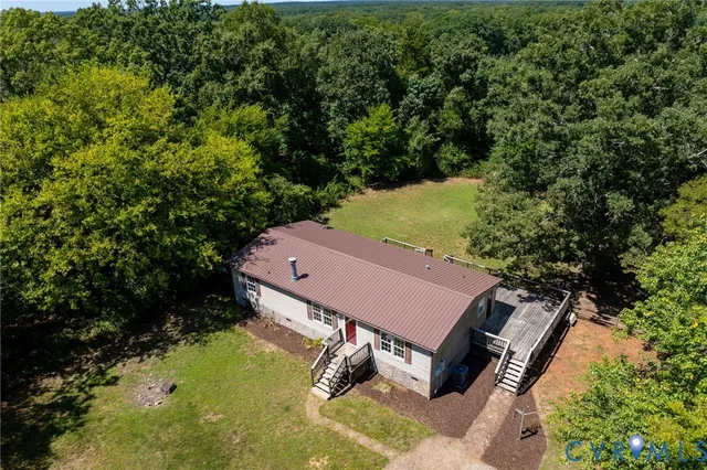 an aerial view of a house with yard swimming pool and outdoor seating