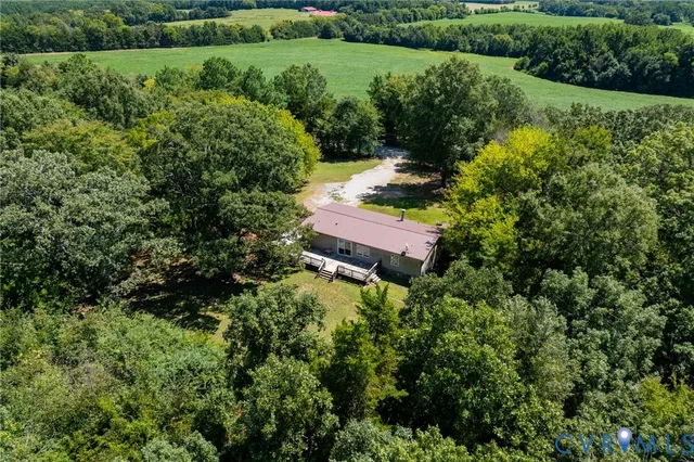an aerial view of a house with a yard