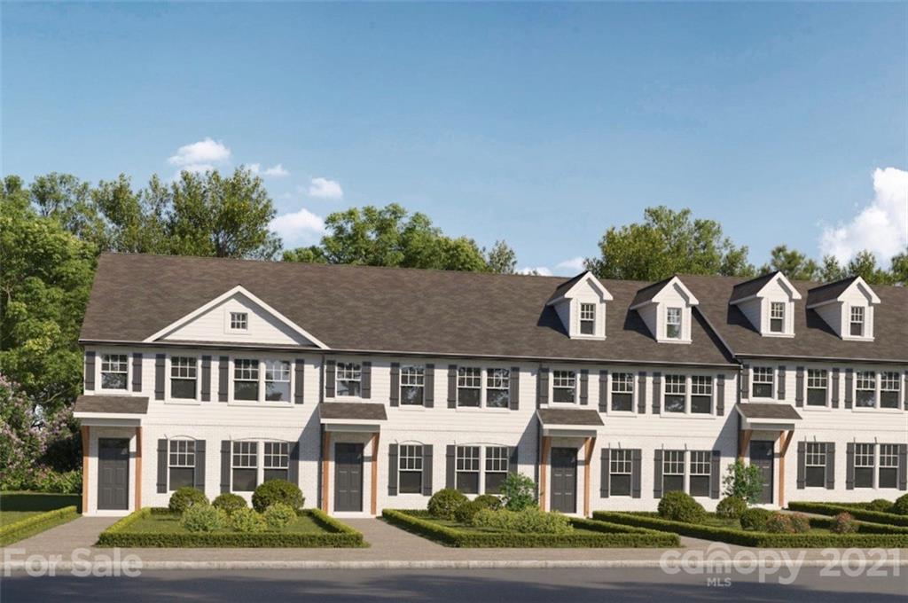 front view of a brick house next to a yard