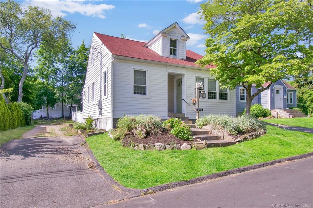 75 Soundview Avenue Fairfield, CT 06825 - Photo 1 of 1 a front view of a house with a yard and potted plants