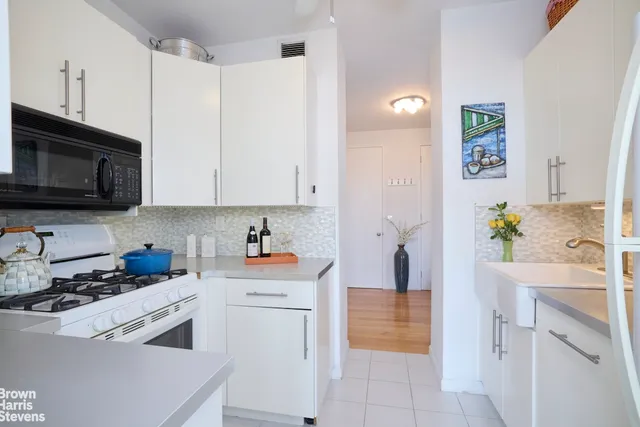 a kitchen with a sink stove and cabinets