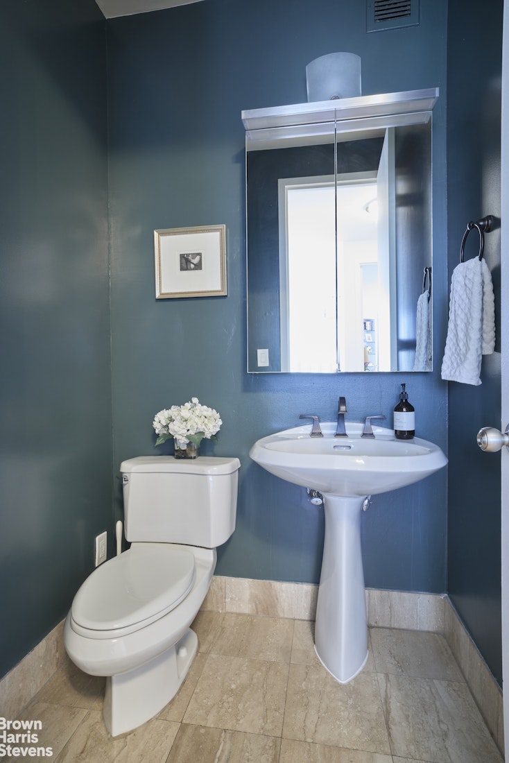 2000 Broadway, Unit 10C Manhattan, NY 10023 - Photo 6 of 16 a bathroom with a sink a toilet and mirror