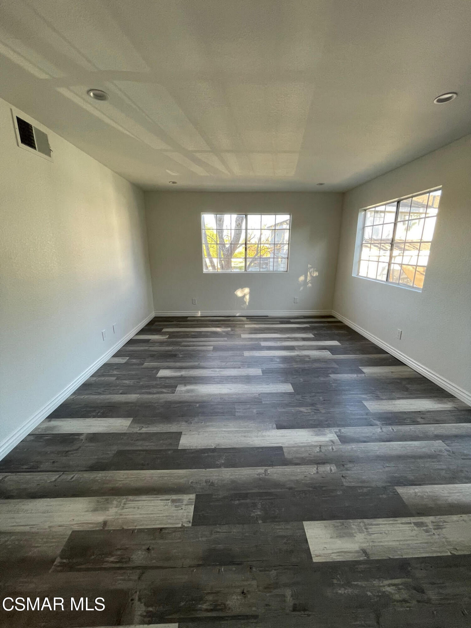 1007 Waltham Road, Unit D Simi Valley, CA 93065 - Photo 3 of 17 a view of empty room with wooden floor and fan