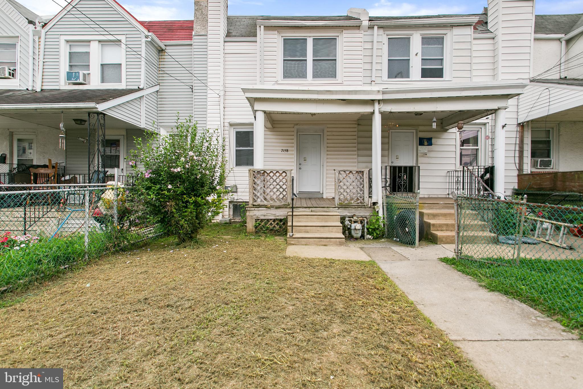 a view of a house with backyard porch and sitting area