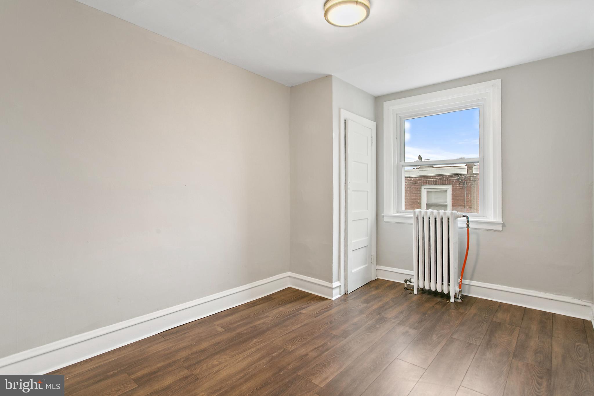 7158 Radbourne Road Upper Darby, PA 19082 - Photo 12 of 15 an empty room with wooden floor and windows
