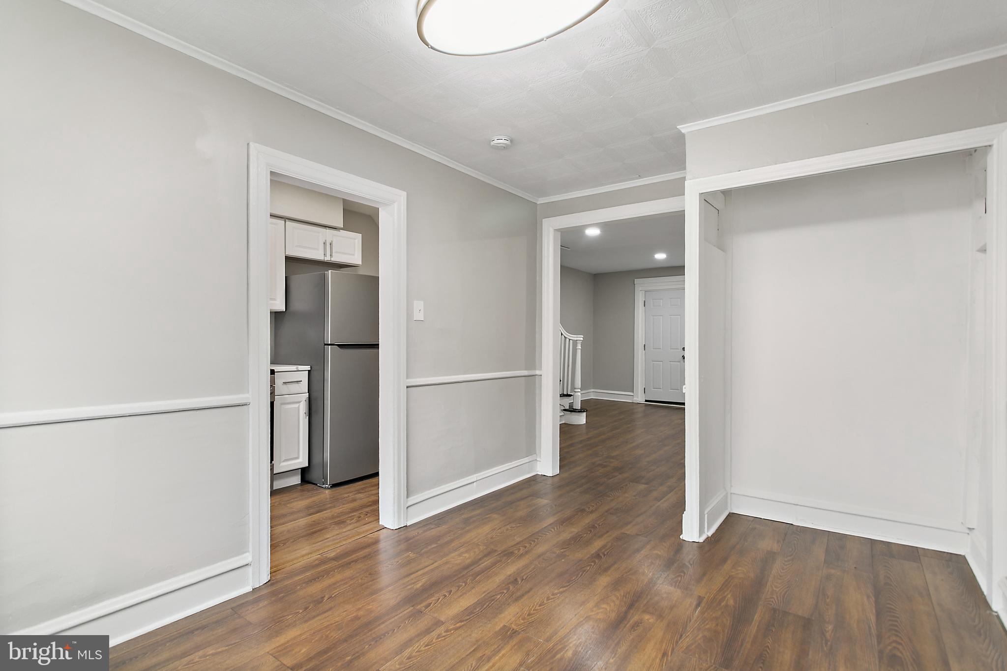 7158 Radbourne Road Upper Darby, PA 19082 - Photo 5 of 15 a view of a kitchen with a refrigerator and wooden floor
