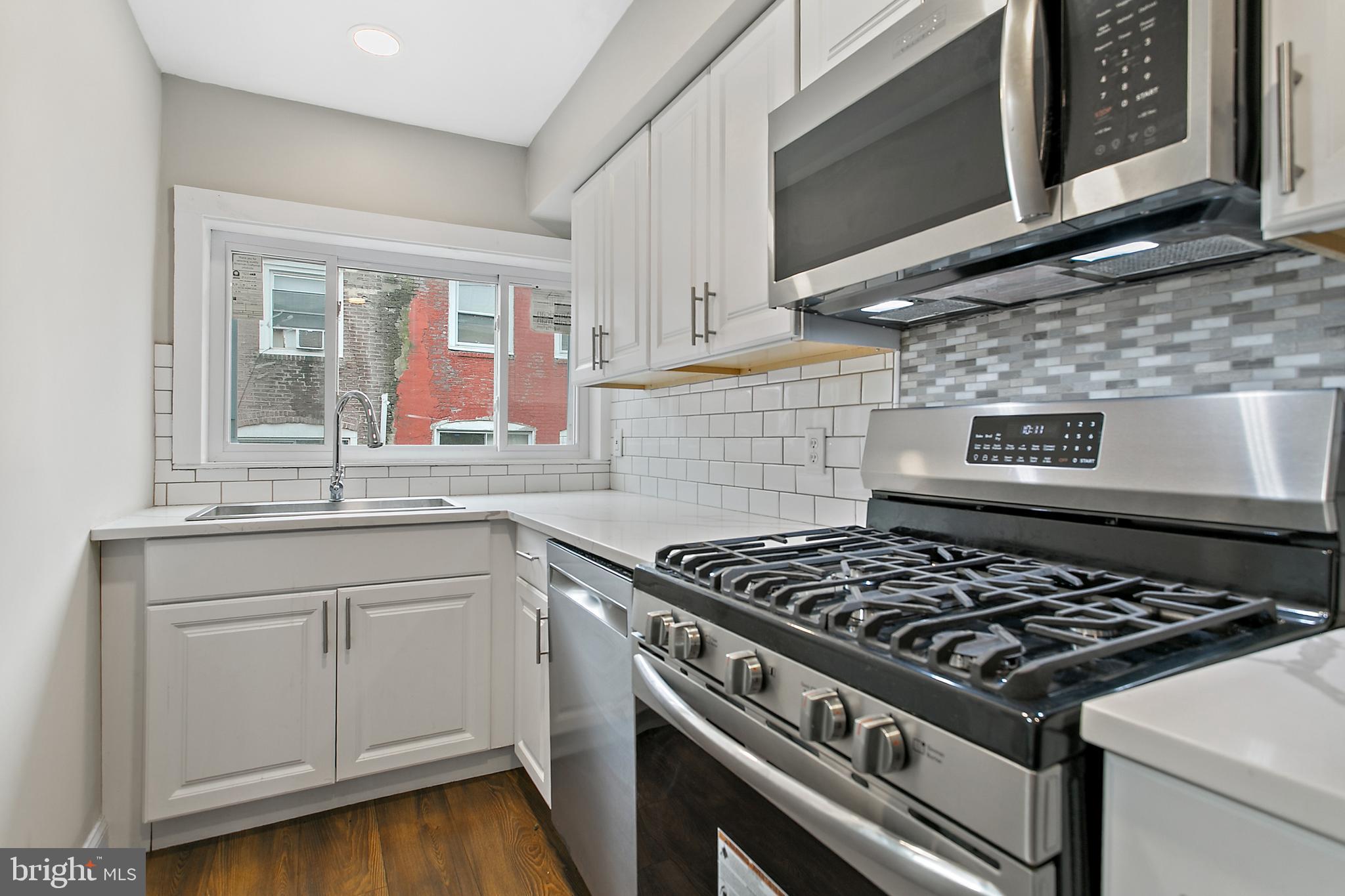 7158 Radbourne Road Upper Darby, PA 19082 - Photo 7 of 15 a stove top oven sitting inside of a kitchen