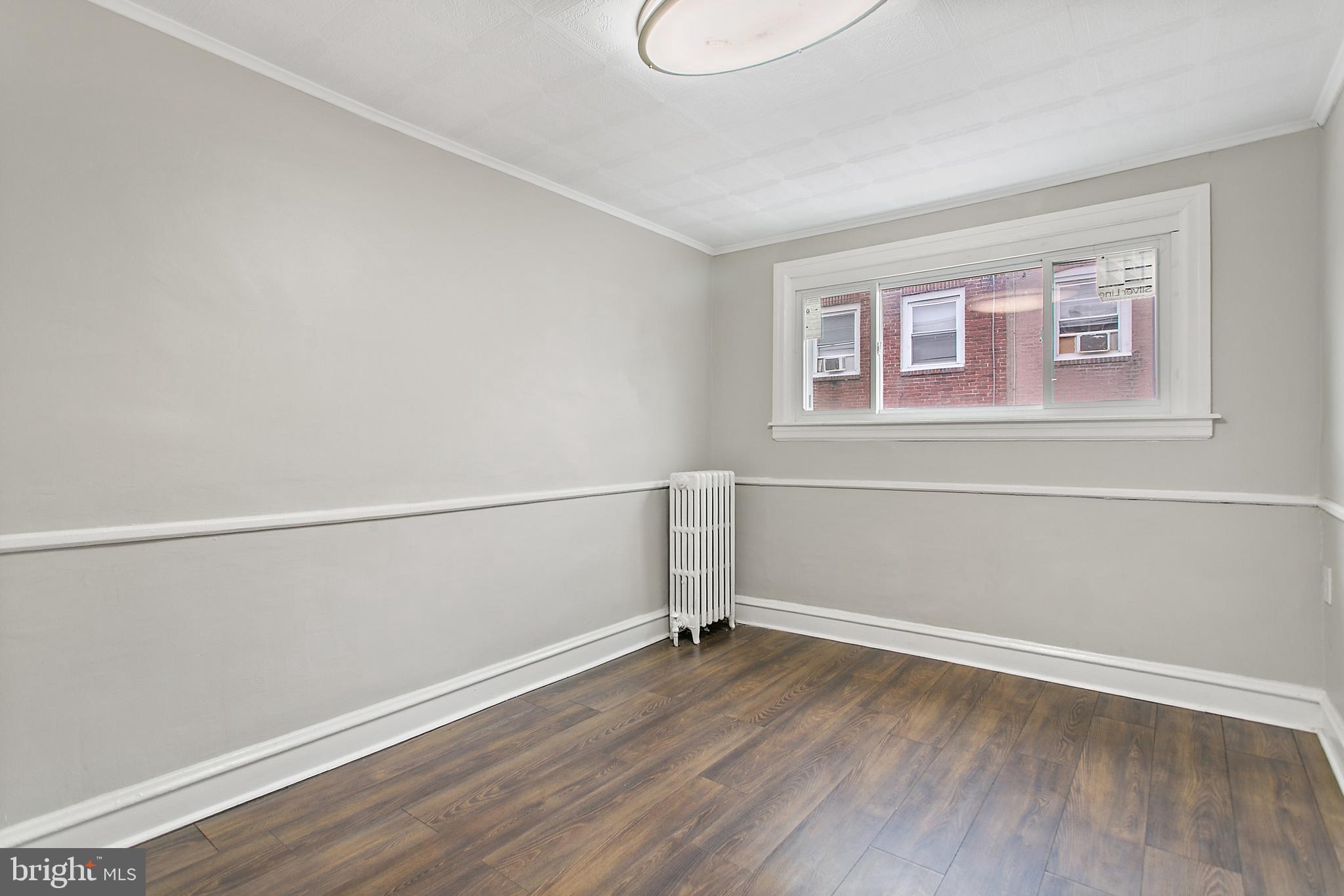 7158 Radbourne Road Upper Darby, PA 19082 - Photo 9 of 15 a view of a room with wooden floor and window