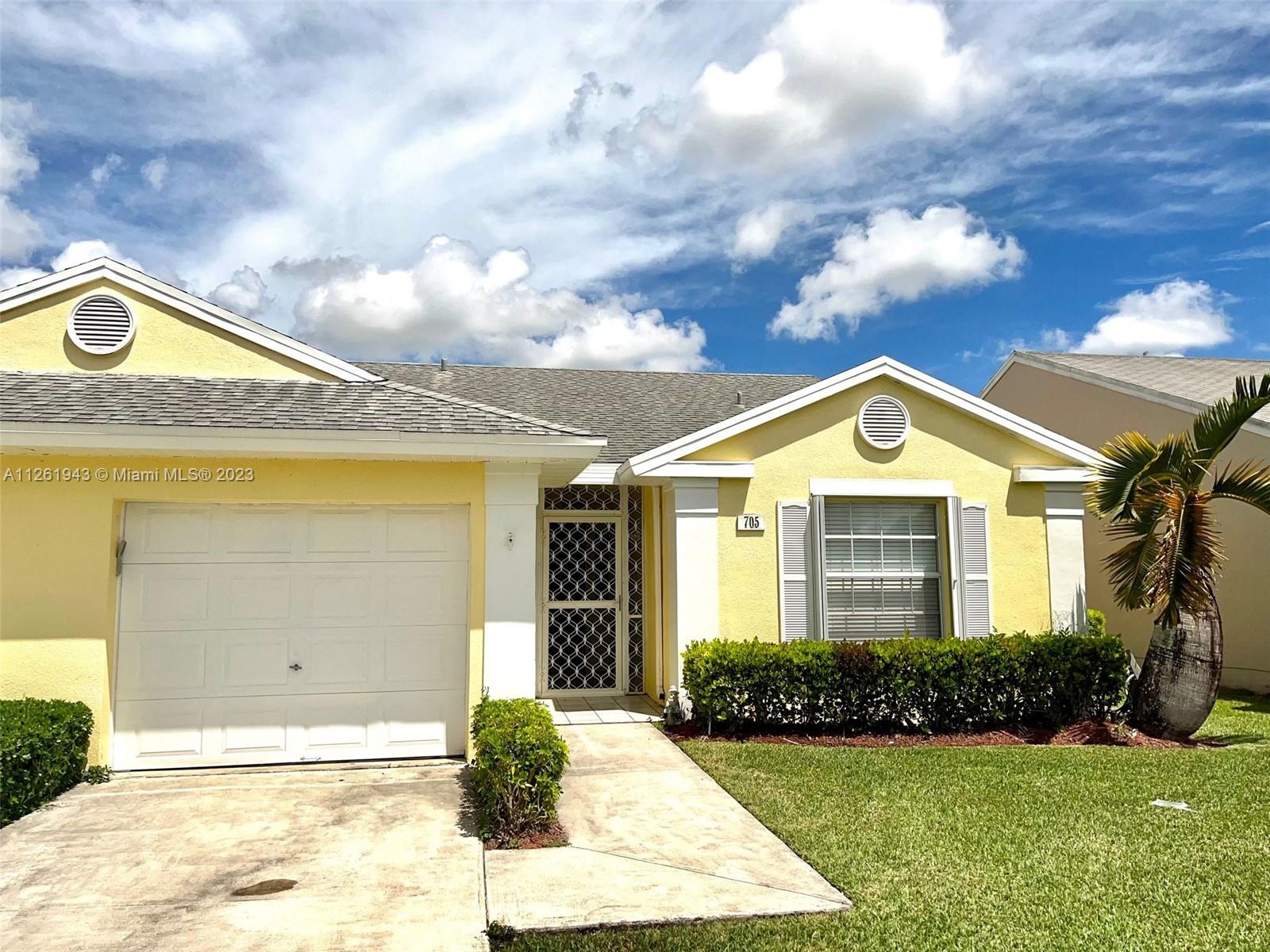 705 Southeast 22nd Lane Homestead, FL 33033 - Photo 1 of 43 a front view of a house with garden