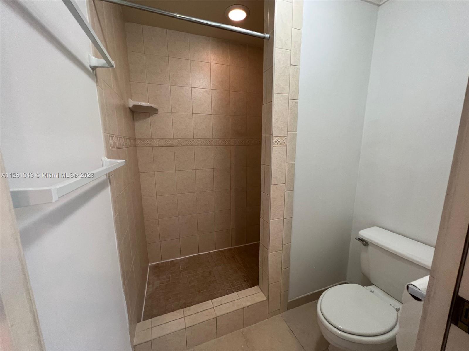705 Southeast 22nd Lane Homestead, FL 33033 - Photo 19 of 43 a white toilet sitting next to a shower
