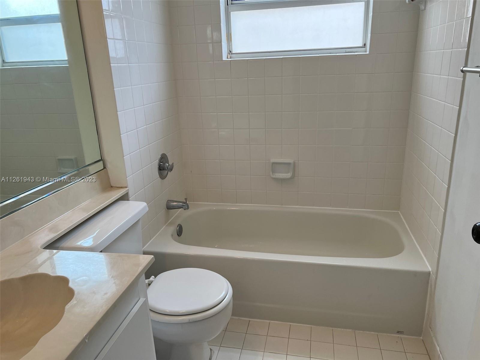 705 Southeast 22nd Lane Homestead, FL 33033 - Photo 21 of 43 a bathroom with a granite countertop toilet and a bathtub