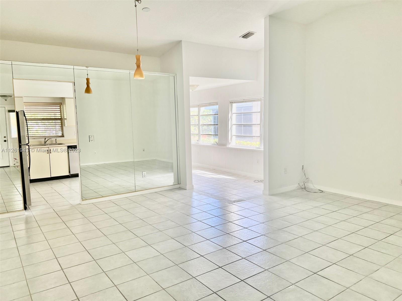 705 Southeast 22nd Lane Homestead, FL 33033 - Photo 4 of 43 a view of an empty room and window