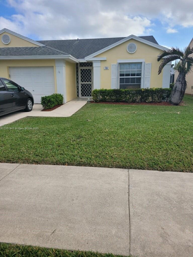 705 Southeast 22nd Lane Homestead, FL 33033 - Photo 43 of 43 a view of a house with a yard and garage