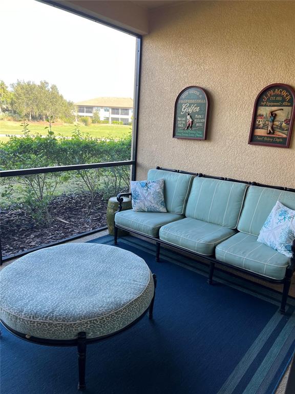 13737 Messina Loop, Unit 101 Bradenton, FL 34211 - Photo 14 of 25 a living room with furniture and a floor to ceiling window