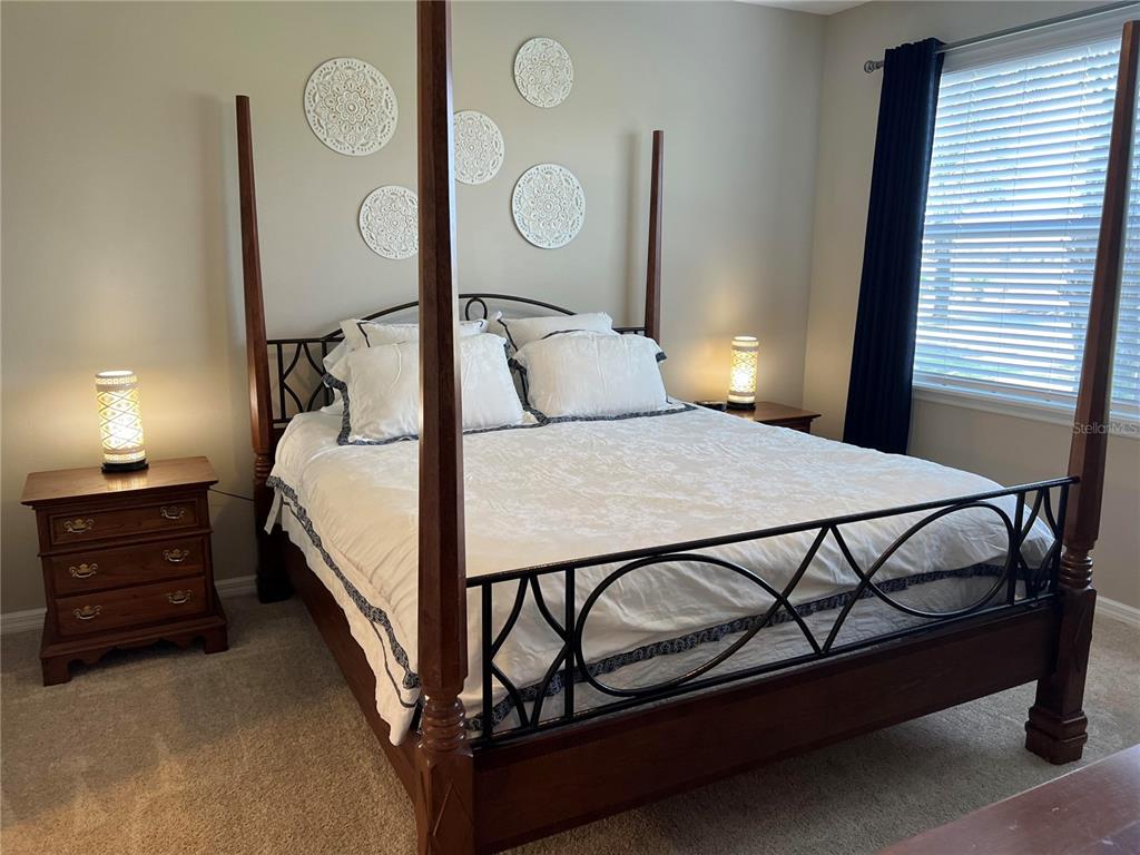 13737 Messina Loop, Unit 101 Bradenton, FL 34211 - Photo 16 of 25 a bed room with a bed and a lamp