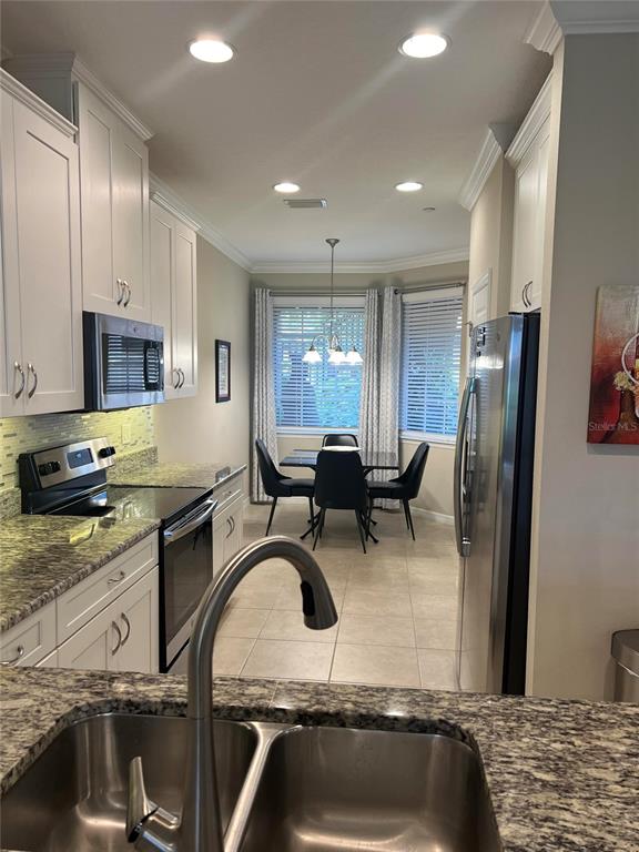 13737 Messina Loop, Unit 101 Bradenton, FL 34211 - Photo 3 of 25 a kitchen with sink refrigerator and stove