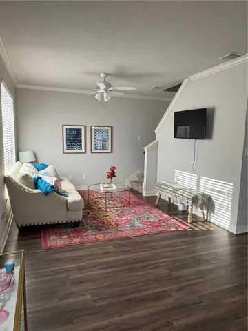a bedroom with furniture and a wooden floor